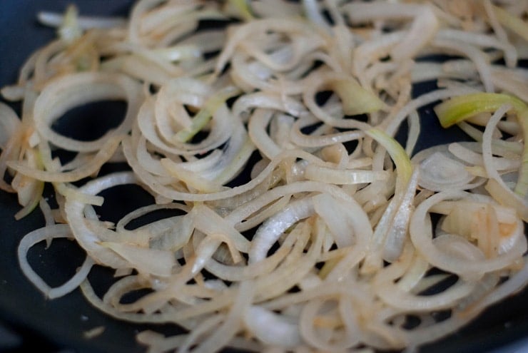 Caramelized Onions in a silver skillet.