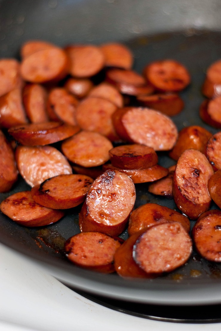 Smoked Sausage in a silver skillet.