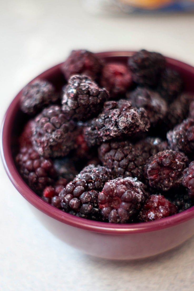 Boysenberries in a small red bowl.