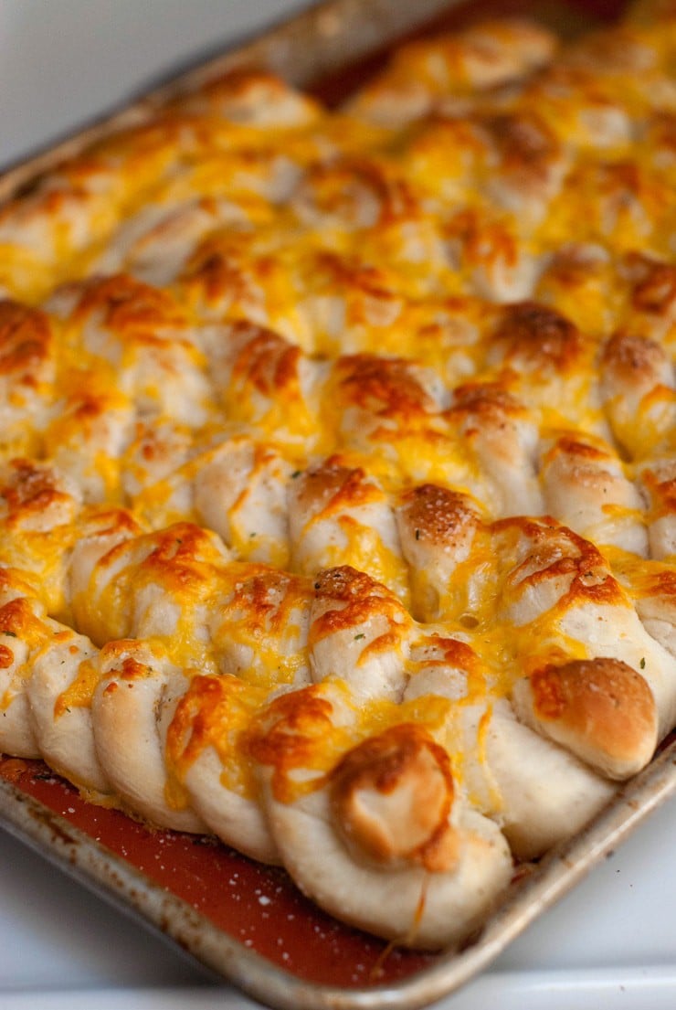 Delicious Soft and Cheesy Garlic Breadsticks in a baking sheet.