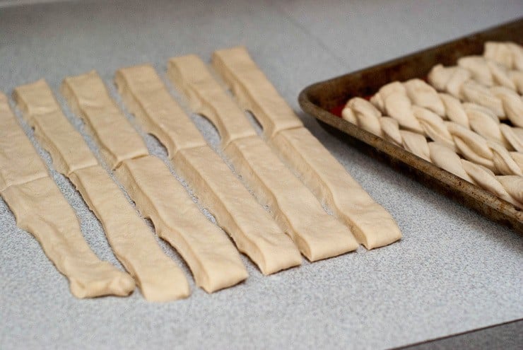 Bread stick dough in rectangle cutouts.