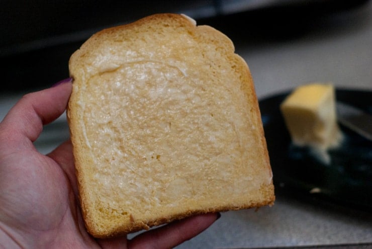 Holding Buttered Bread.