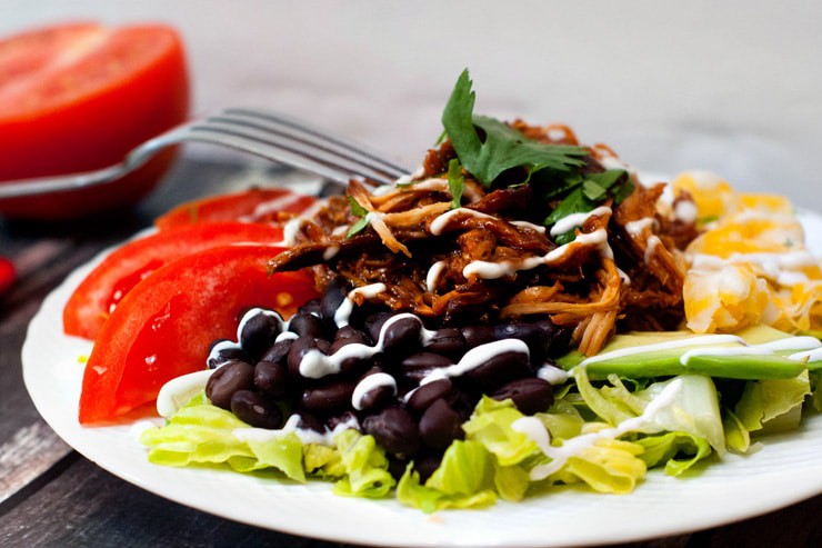 Delicious Slow Cooker BBQ Chicken Taco Salad with black beans and tomatoes.