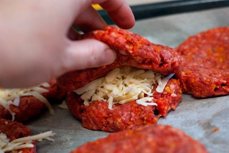 Stuffing shredded Pepper Jack cheese into Dorito Burger patties.