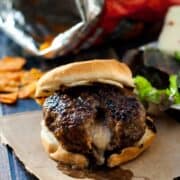 Delicious Pepper Jack Stuffed Doritos Burger on a wooden table.