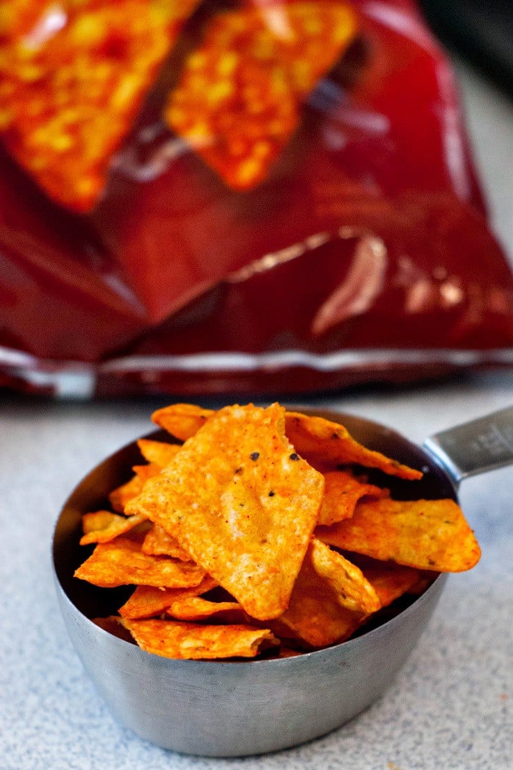 Doritos in a silver measuring cup.