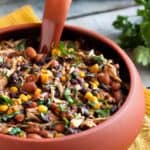 Large red bowl of delicious Slow Cooker Salsa Chicken Chili with corn and beans.