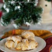 Easy Cottage Cheese Cheese Horns drizzled with glaze on a white serving plate.