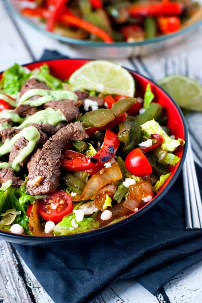 Skillet Steak Fajita Salad in Red Bowl with fork