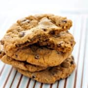 Big Chewy Chocolate Chip Cookies just like you get at the bakery. Crisp around the edges, soft in the middle and filled with chocolate, these cookies are spectacular-- espcially with a big glass of milk! The secret is in letting the dough sit in the fridge overnight to let the flavor develop and become rich and buttery. Find more excellent recipes at Heather Likes Food .com!