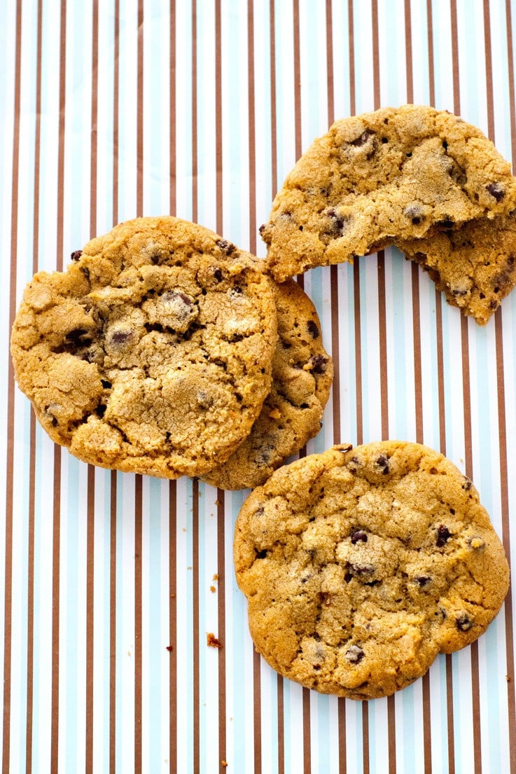 Big Chewy Chocolate Chip Cookies just like you get at the bakery. Crisp around the edges, soft in the middle and filled with chocolate, these cookies are spectacular-- espcially with a big glass of milk! The secret is in letting the dough sit in the fridge overnight to let the flavor develop and become rich and buttery. Find more excellent recipes at Heather Likes Food .com! 