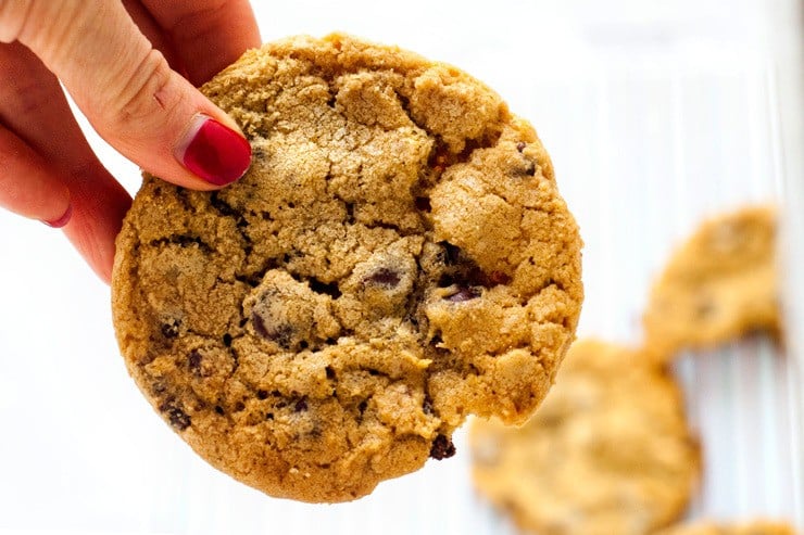 Big Chewy Chocolate Chip Cookies just like you get at the bakery. Crisp around the edges, soft in the middle and filled with chocolate, these cookies are spectacular-- espcially with a big glass of milk! The secret is in letting the dough sit in the fridge overnight to let the flavor develop and become rich and buttery. Find more excellent recipes at Heather Likes Food .com!