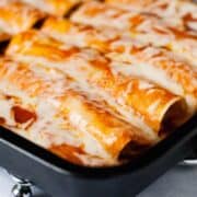 Taco Chicken Enchiladas: Throw some chicken in the slow cooker with some taco seasoning, cook, shred, and roll up in corn tortillas. Top with enchilada sauce and monterrey jack cheese . Makes enchiladas everyone loves!