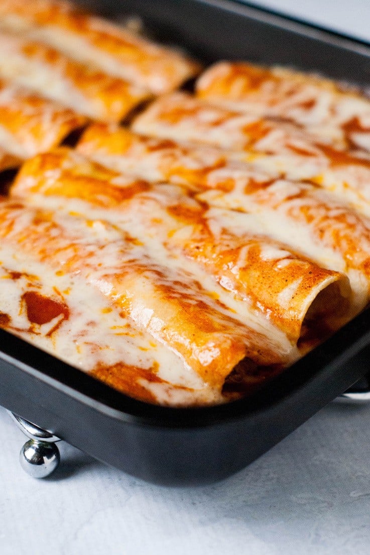Taco Chicken Enchiladas: Throw some chicken in the slow cooker with some taco seasoning, cook, shred, and roll up in corn tortillas. Top with enchilada sauce and monterrey jack cheese . Makes enchiladas everyone loves!