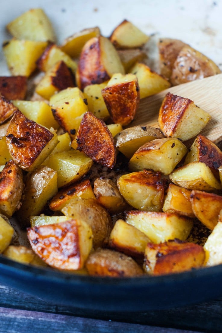 These Super Crispy Oven Roasted Garlic Potatoes are what my dreams are made of. They are made quick and easy in the oven and take just a few minutes to throw together, making them a perfectly quick side for dinner! 