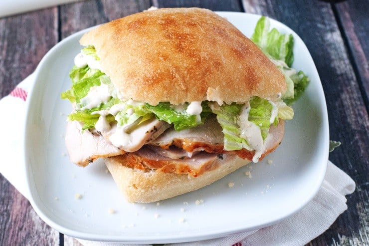 Pork tenderloin sandwich on a white plate