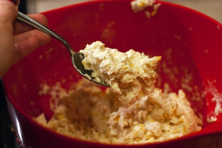 biscuit dough being mixed in a red bowl