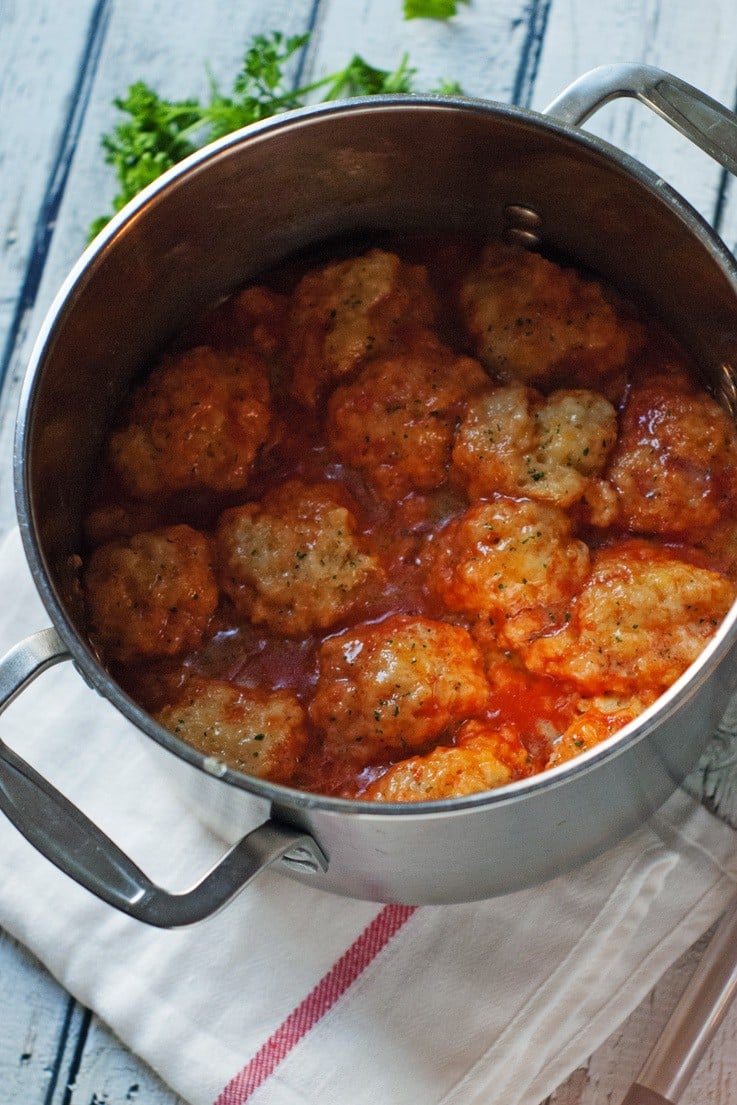 Pot with tomato soup and cheese dumplings in it