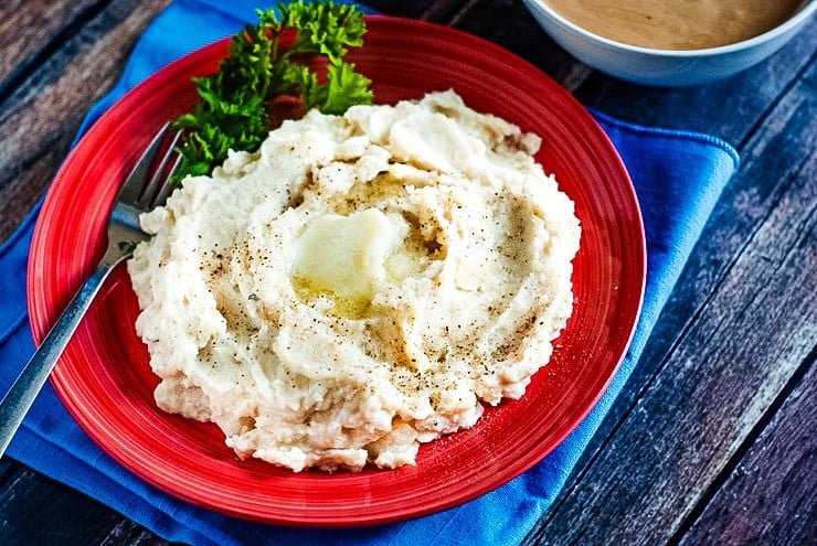 Crock Pot Mashed Potatoes served on a red plate