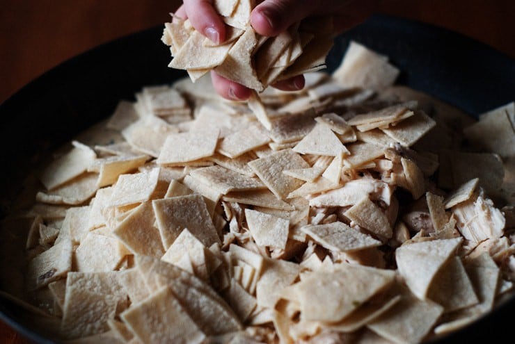 Cut tortillas for sour cream enchiladas skillet