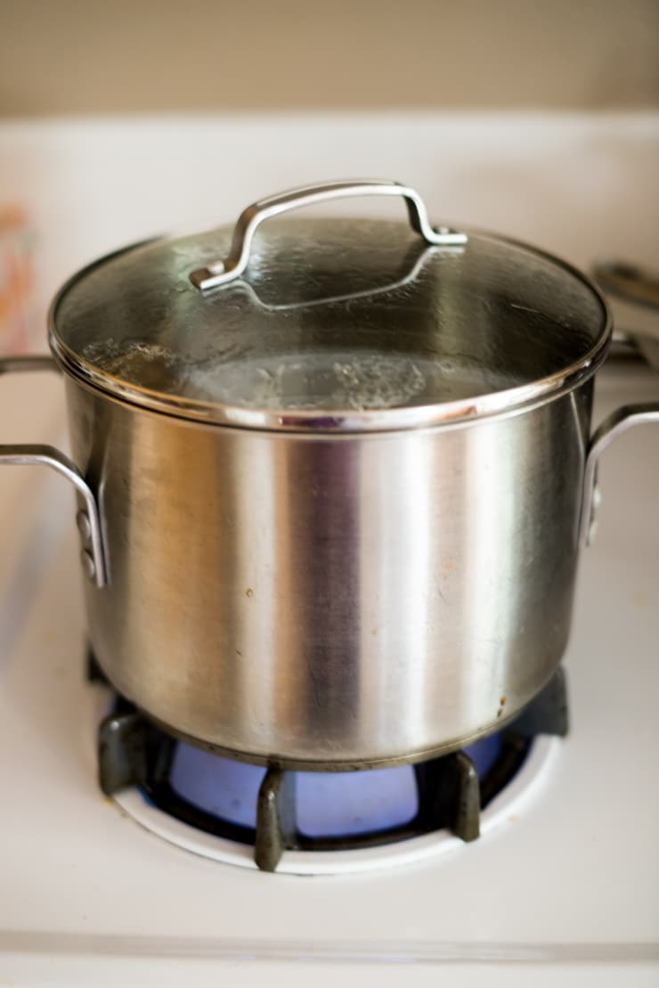 A pot cooking perfect brown rice on the stove top