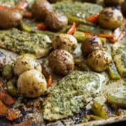 Sheet Pan Pesto Chicken and Veggies-- it only takes one pan for this sheet pan supper! Chicken breasts, mini potatoes and bell peppers are topped with basil pesto and baked! So good and so, so easy! No dishes and No mess!