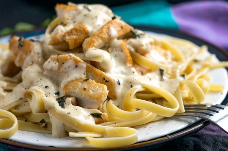 Chicken Fettuccini with alfredo sauce on a white plate