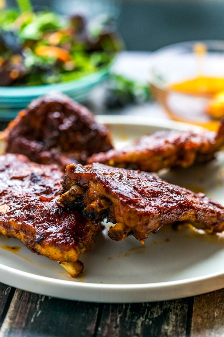 BBQ ribs made in the Instant Pot on a white plate with salad 