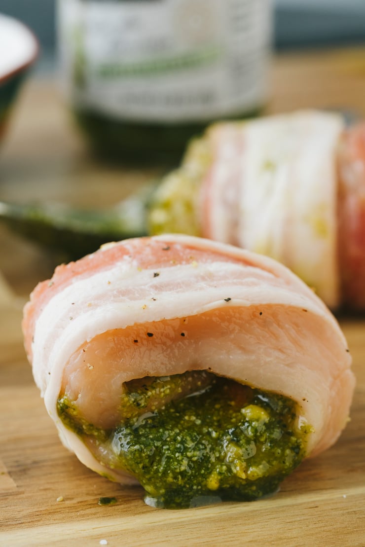 Bacon wrapped pesto chicken before baking