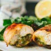 The easiest, moistest, most flavorful chicken ever! This bacon wrapped pesto chicken is packed with flavor and takes only 15 minutes to bake under the broiler. making it a perfect weeknight meal!