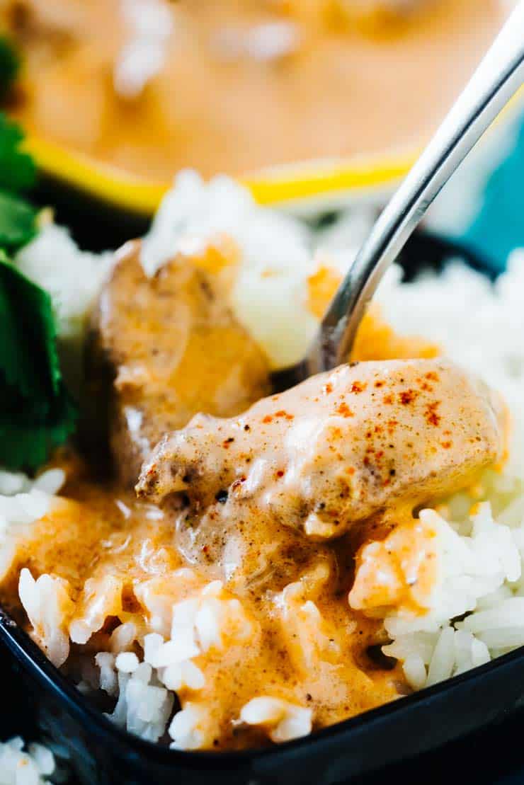 Indian Butter Chicken on rice with a spoon
