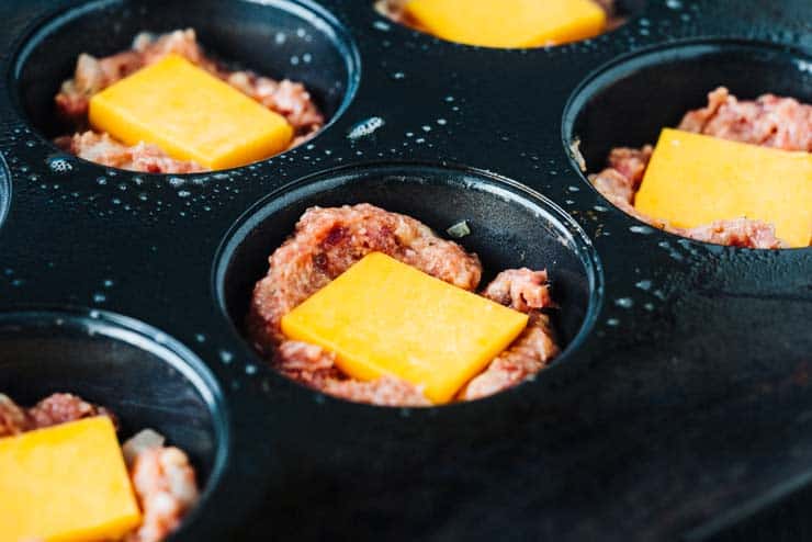 Meatloaf mix in non-stick pan with cheese slices on top