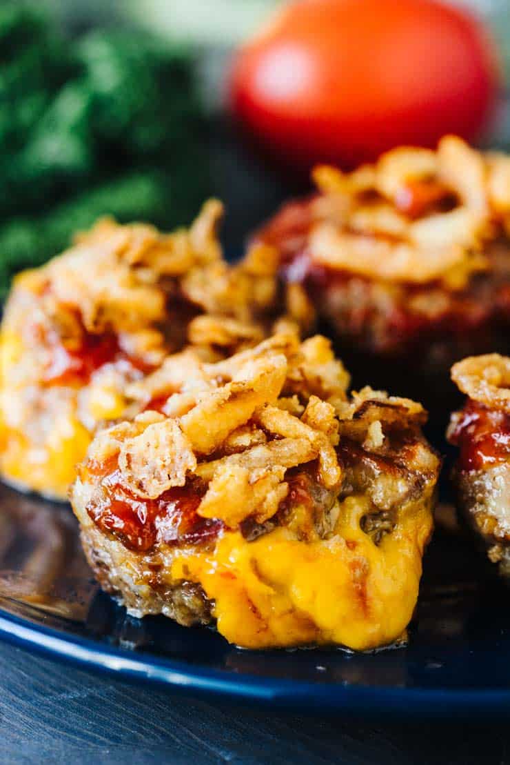 Bacon Cheddar Mini Meatloaf Muffins on a blue plate with french fried onions on top