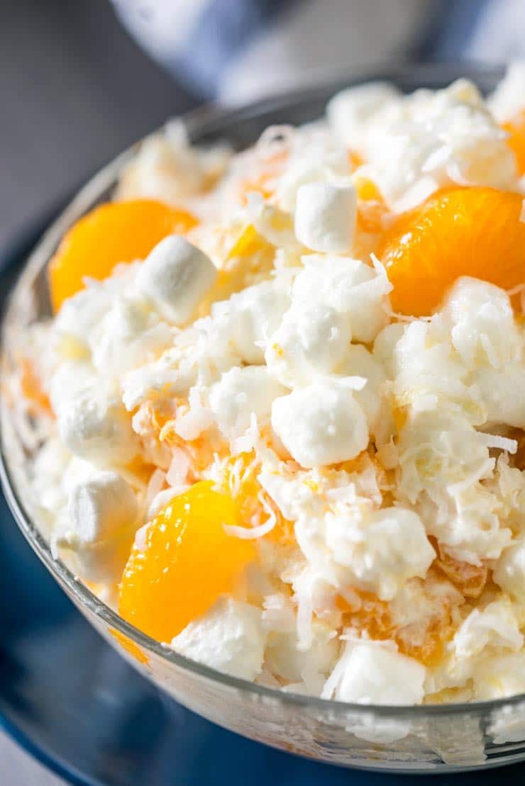 Close up of Ambrosia salad-- marshmallows, cool whip, sour cream, mandarin oranges.