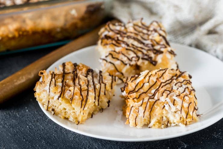Sliced Coconut Macaroon Cookie Bars on a white plate