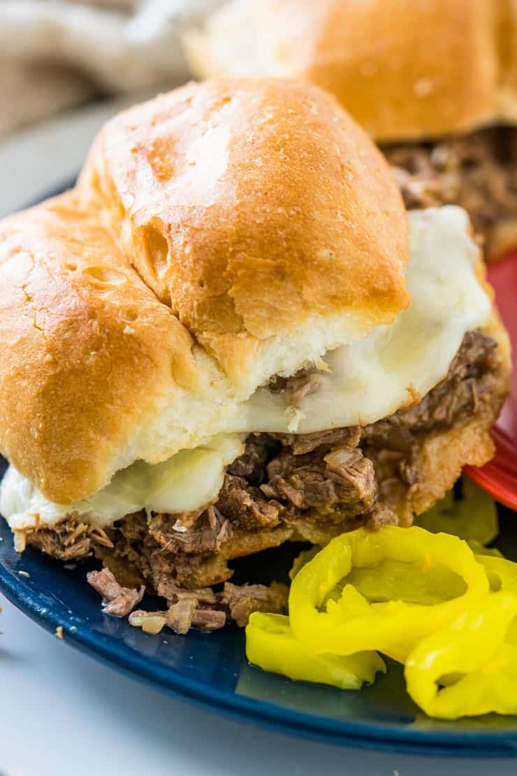 Slow Cooker Italian Beef Sandwich on blue Plate with peppers