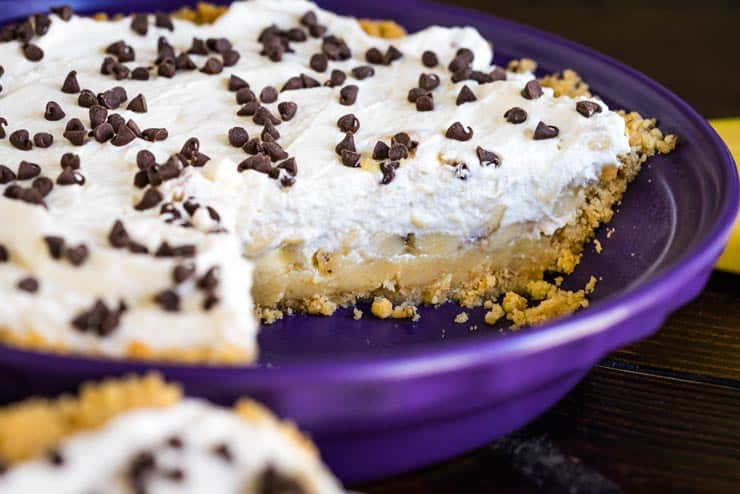 Banoffee Pie with shortbread crust in a purple pie dish