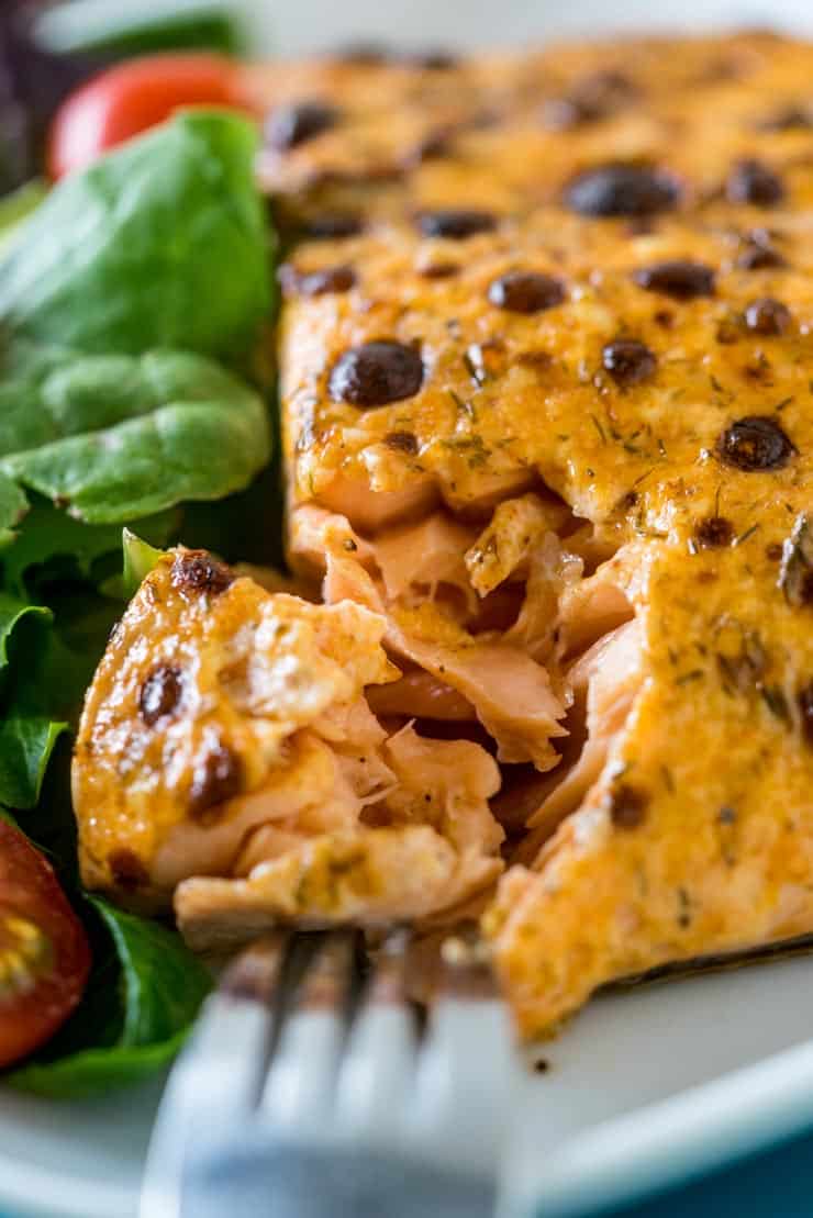 Broiled and Baked Salmon with Mayonnaise on a plate with salad