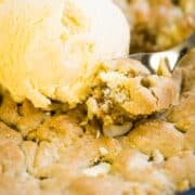 Close up of white chocolate chip macadamia nut pizookie and vanilla ice cream