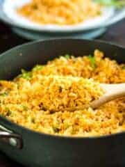 Mexican Spanish Rice in pan with wooden spoon