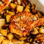 Garlic chicken and potatoes in a white dish