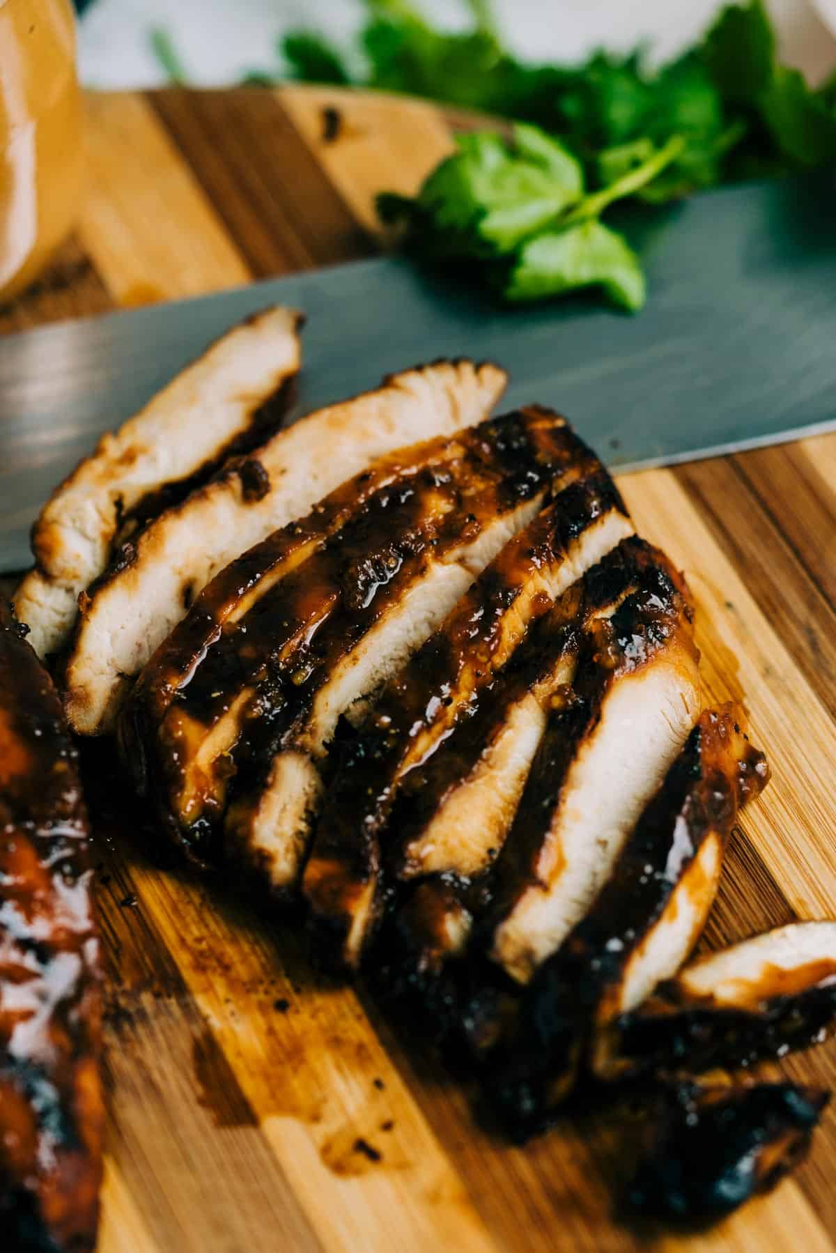 Sliced Thai chicken breast on a cutting board